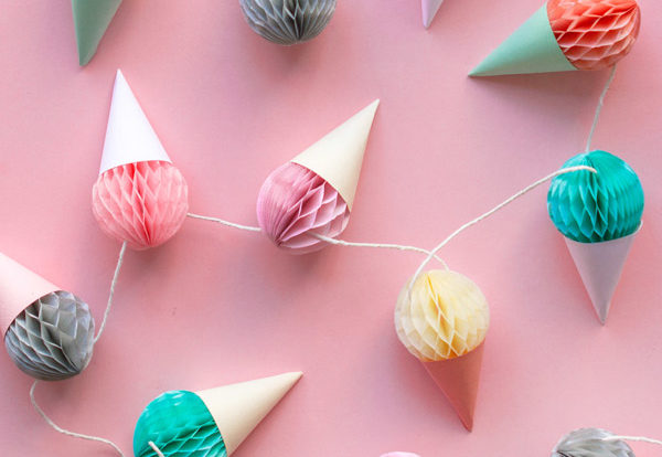 Photo of a garland of ice cream on a pink wall